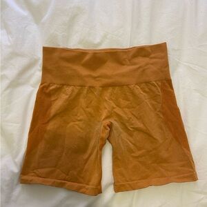 NVGTN orange gym shorts
Contour design